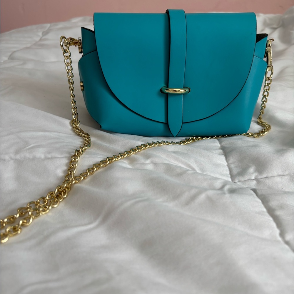 Pelle Pelle Blue and Gold Crossbody Bag with Flap Closure